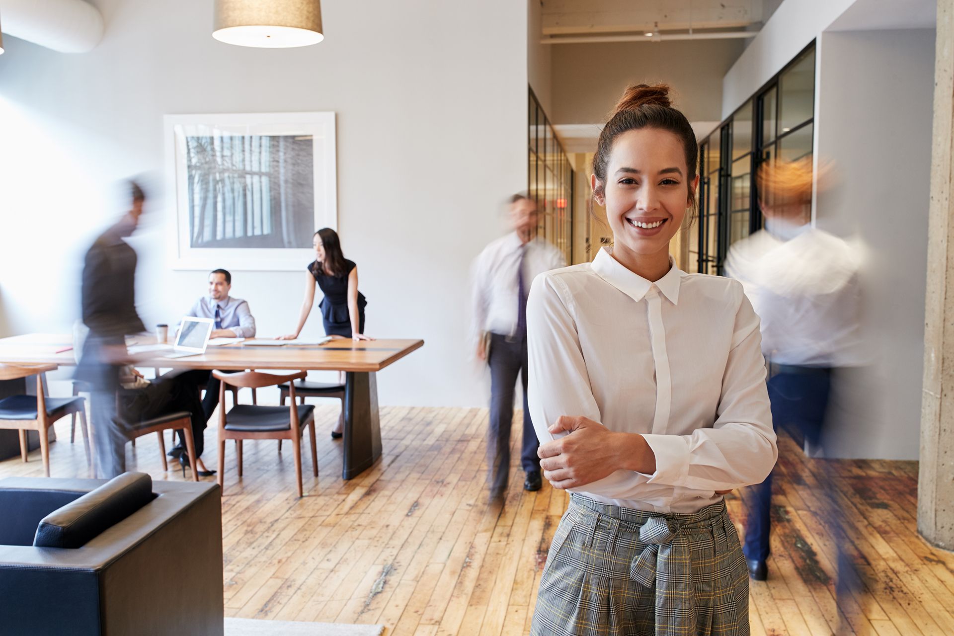 Student standing and facing camera in busy office