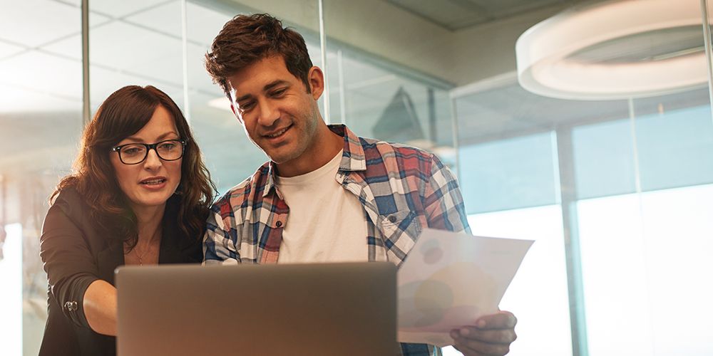 Man and woman looking at a laptop screen