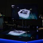 A group of students standing in the HIVE wearing virtual reality glasses - play video