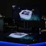 A group of students standing in the HIVE wearing virtual reality glasses - play video