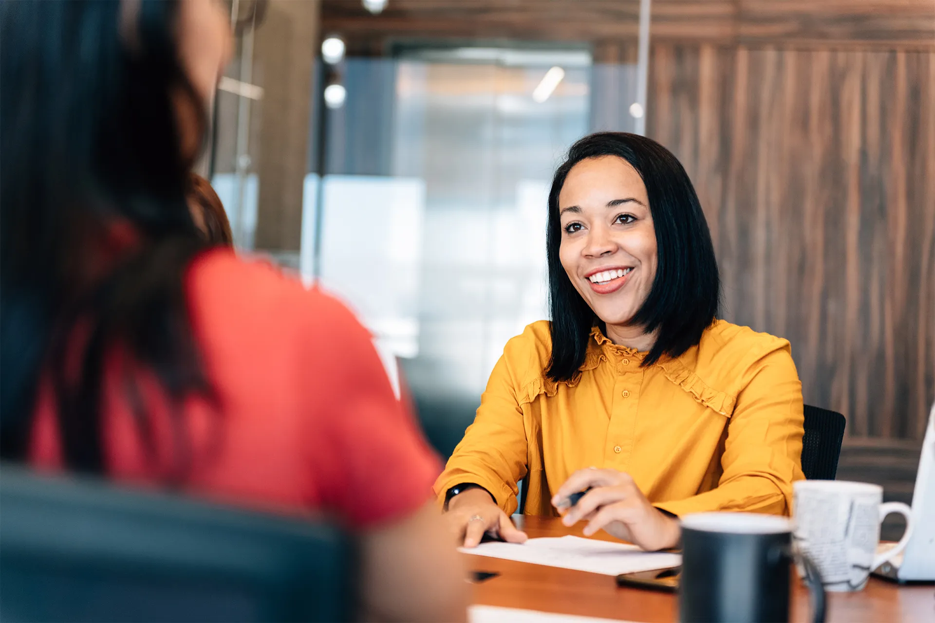 Woman in yellow top having a conversation