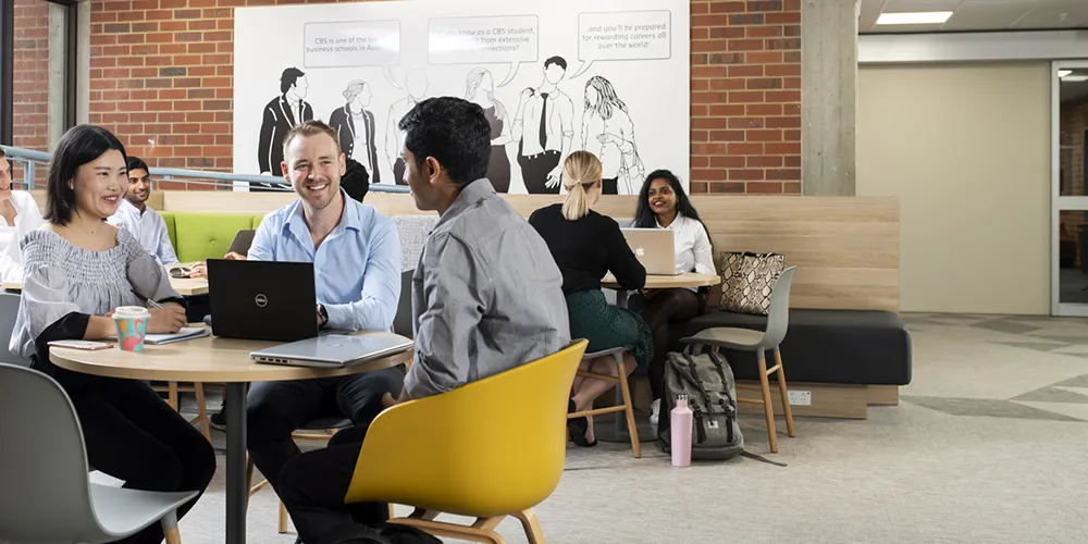 Students sitting around a table in a study area