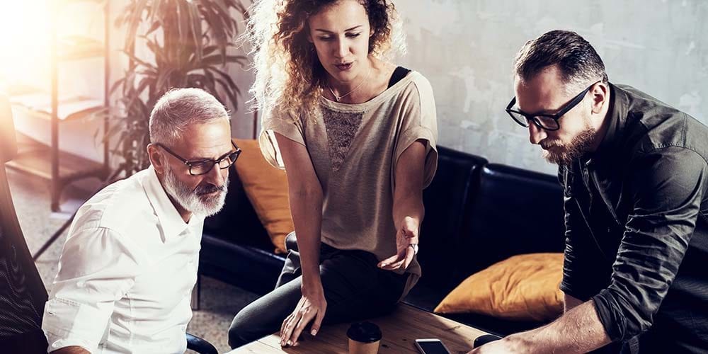 Young team of successful businessman found a great creative solution in modern coworking studio.Bearded man talking with colleagues about startup project.Business people brainstorm concept. - play video