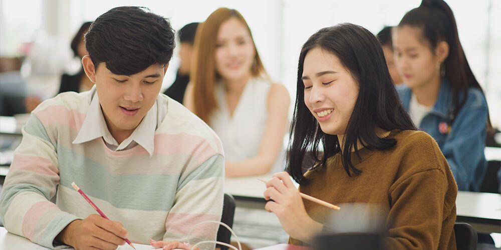 Two students working together in a classroom