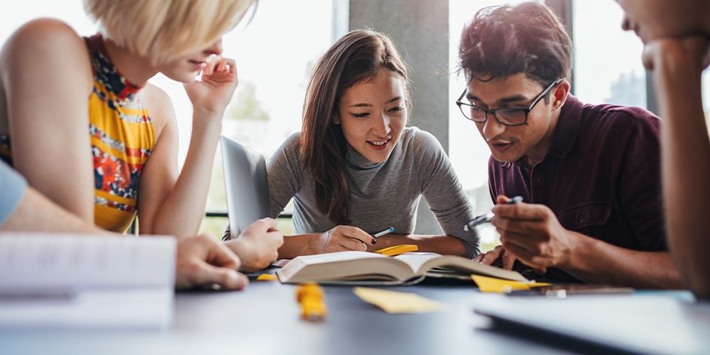 Two students reading a text book