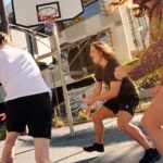 Students playing basketball on campus