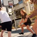 Students playing basketball on campus