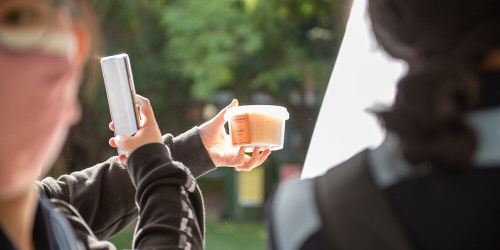 Students taking photos of free food - play video