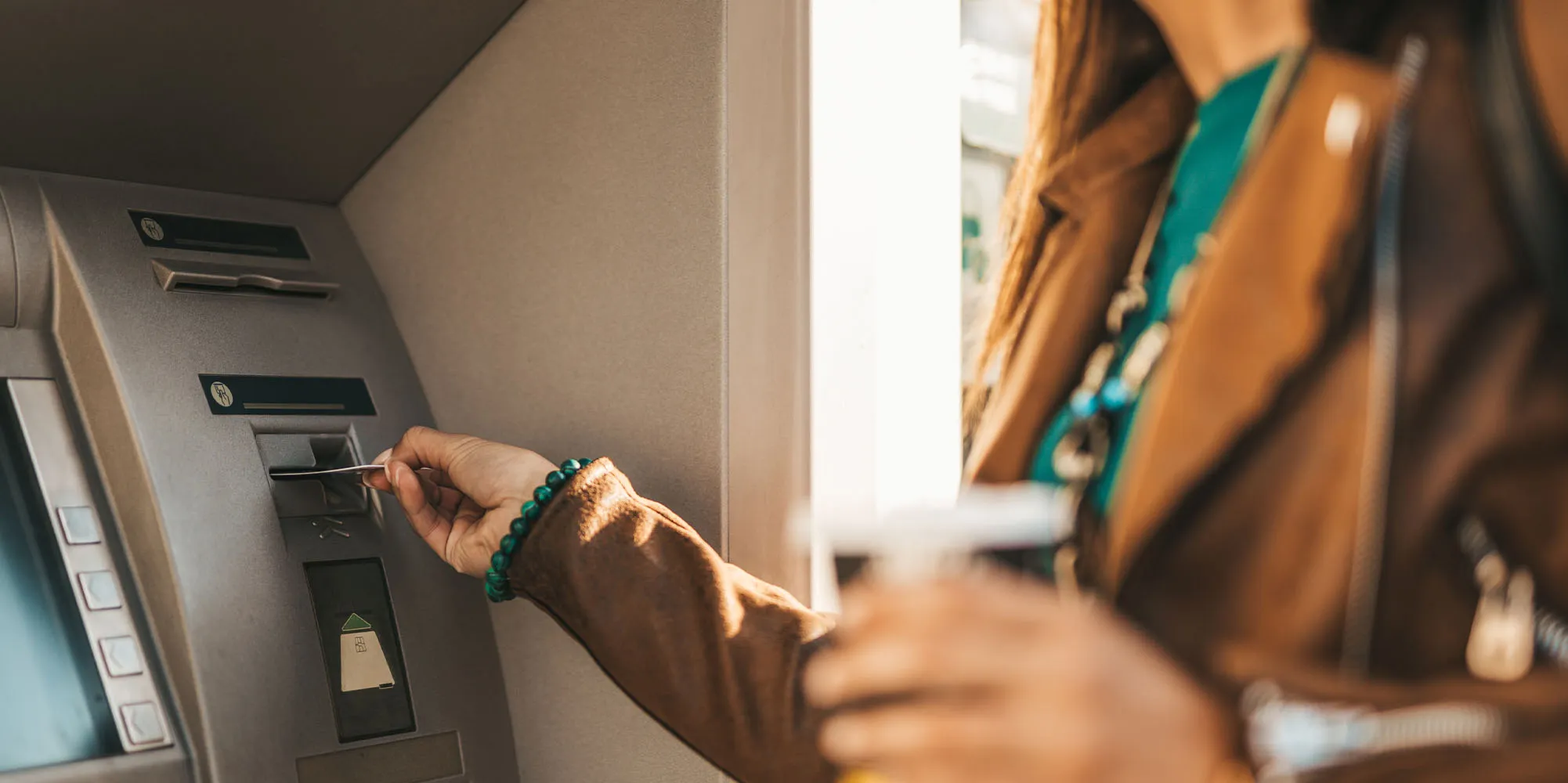 A girl using an ATM