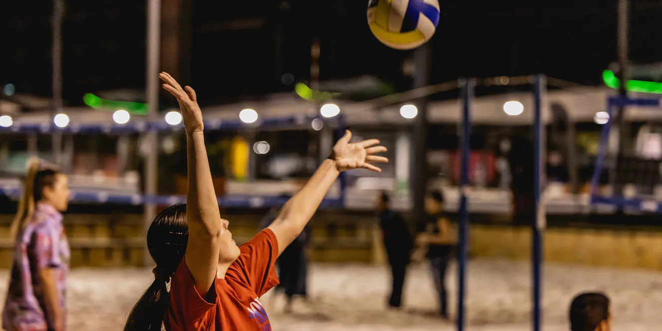 Students playing beach volleyball