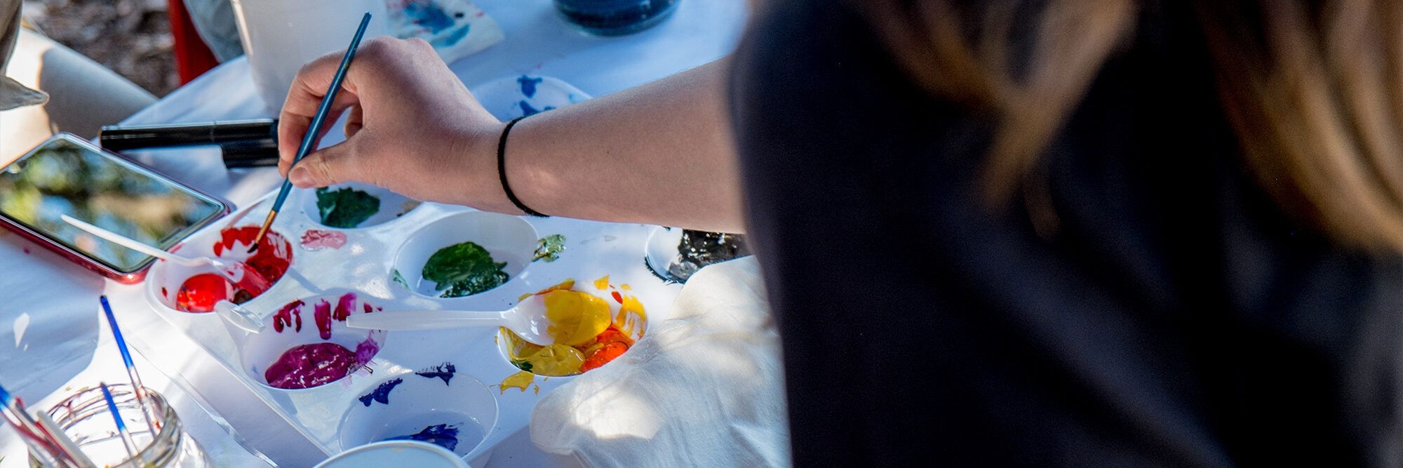 Students painting at a free event