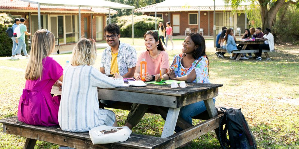 vickery house exterior students at a picnic table