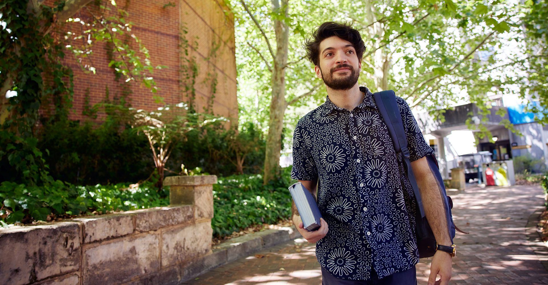 Student walking down a pathway outdoors