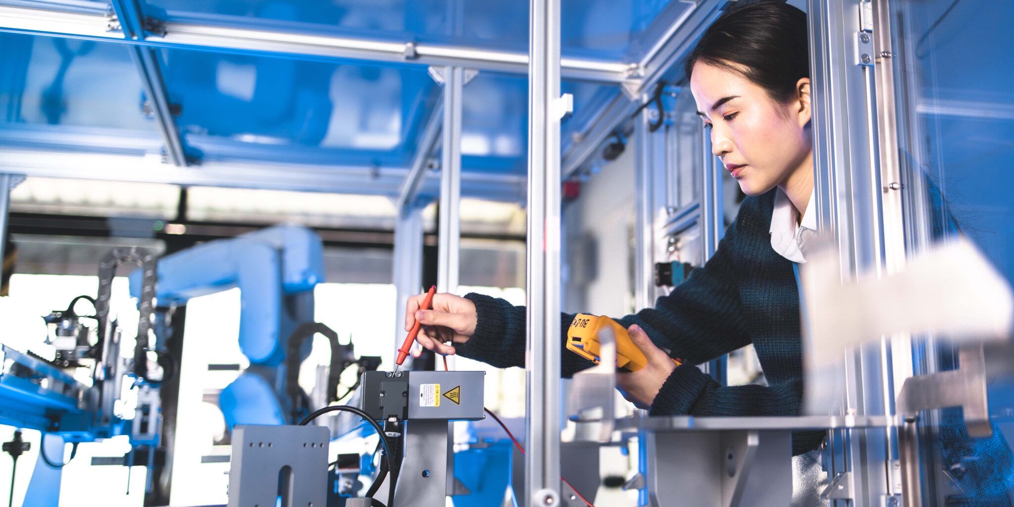 Female Engineers Maintenance Robot Arm at Lab. She are in a High Tech Research Laboratory with Modern Equipment. Technology and Innovation Concept.Professional Japanese Development Engineer is Testing an Artificial Intelligence.start up concept