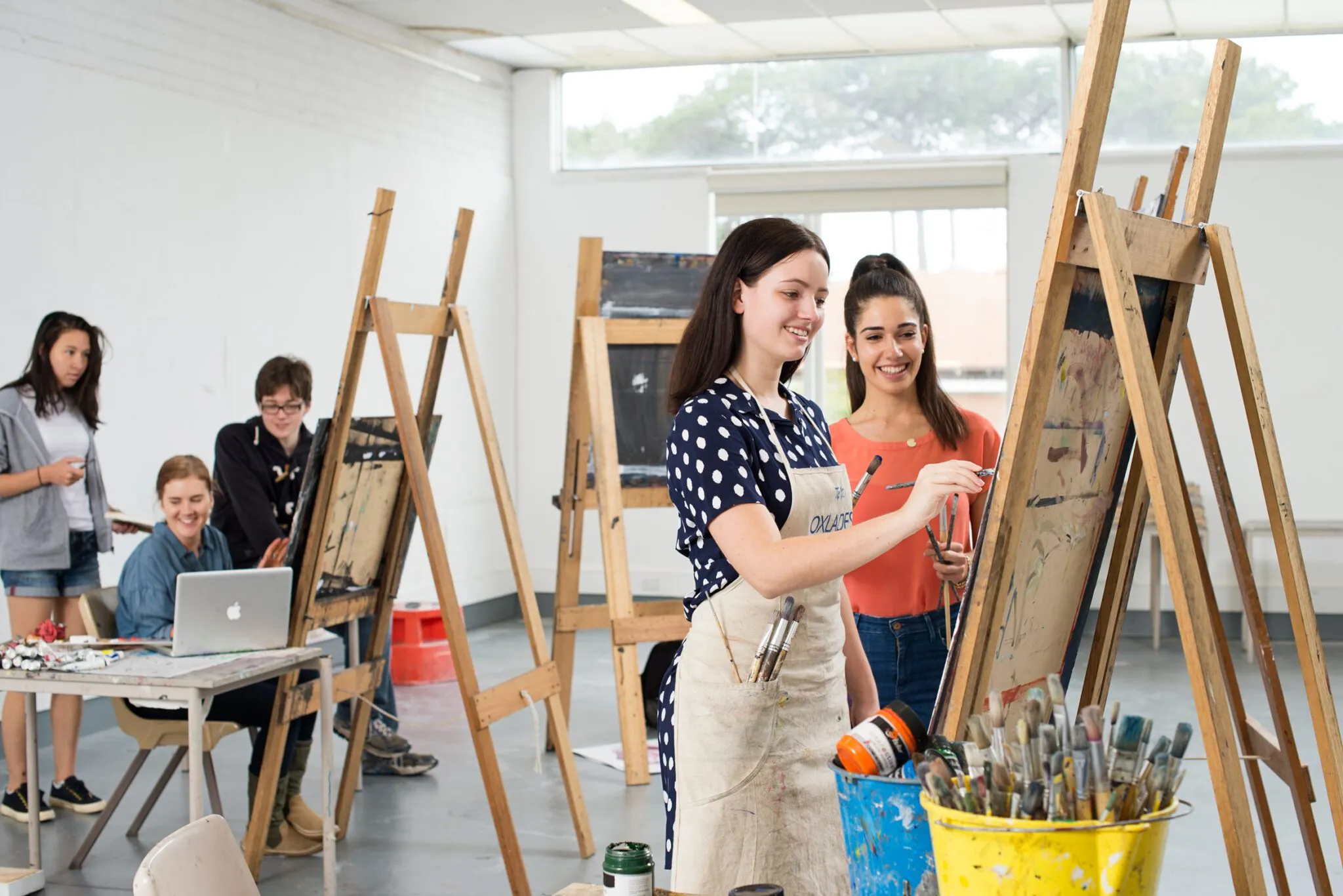 Art students painting on canvas