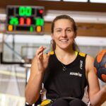 Curtin student playing basketball while using a wheelchair