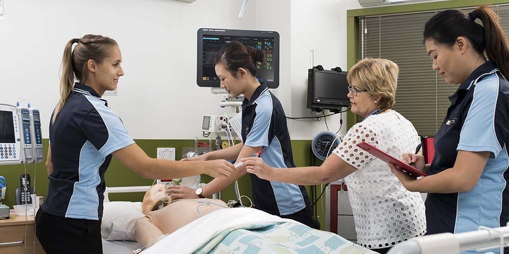 Female nursing students learning in a clinical setting