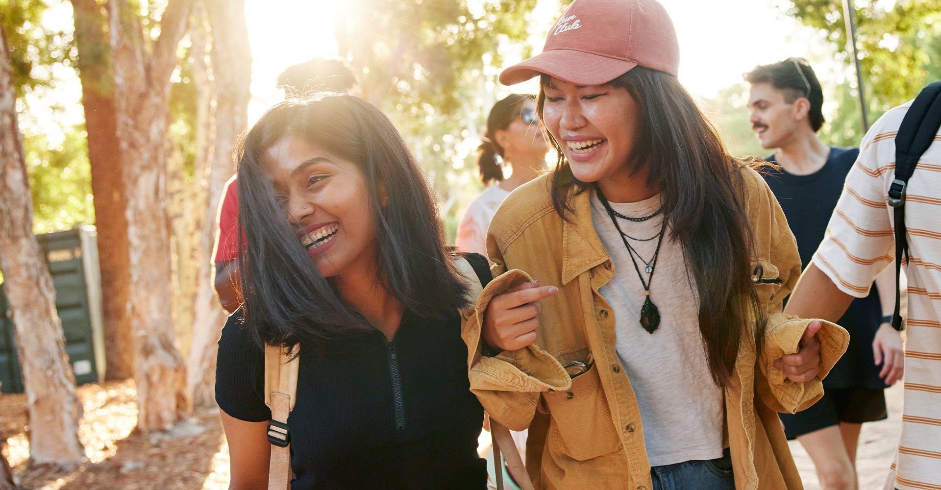 Group of students laughing as they walk through university