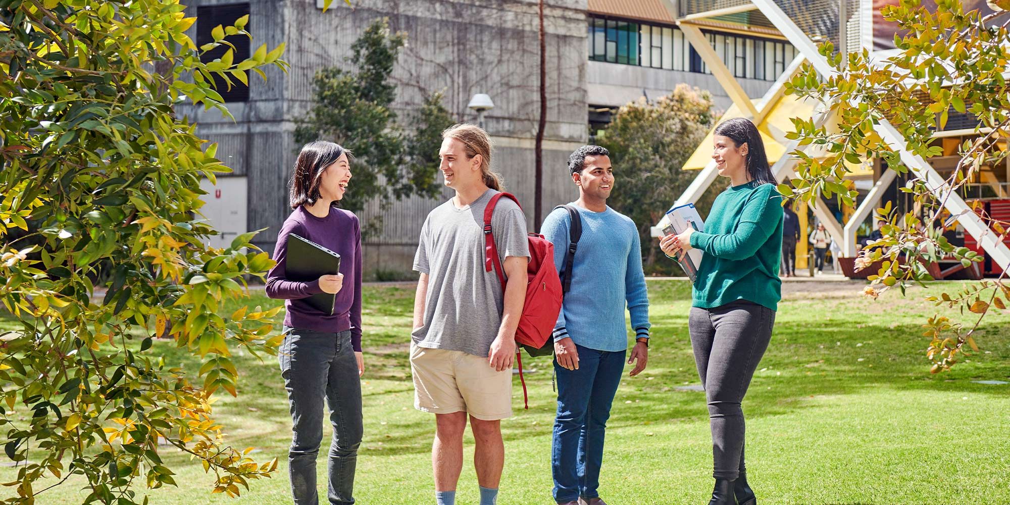 Four undergraduate students standing on the lawn in front of Curtin's engineering pavilion