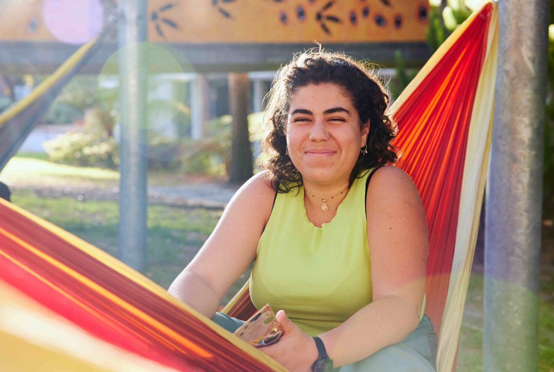 young-female-student-sitting-on-hammock