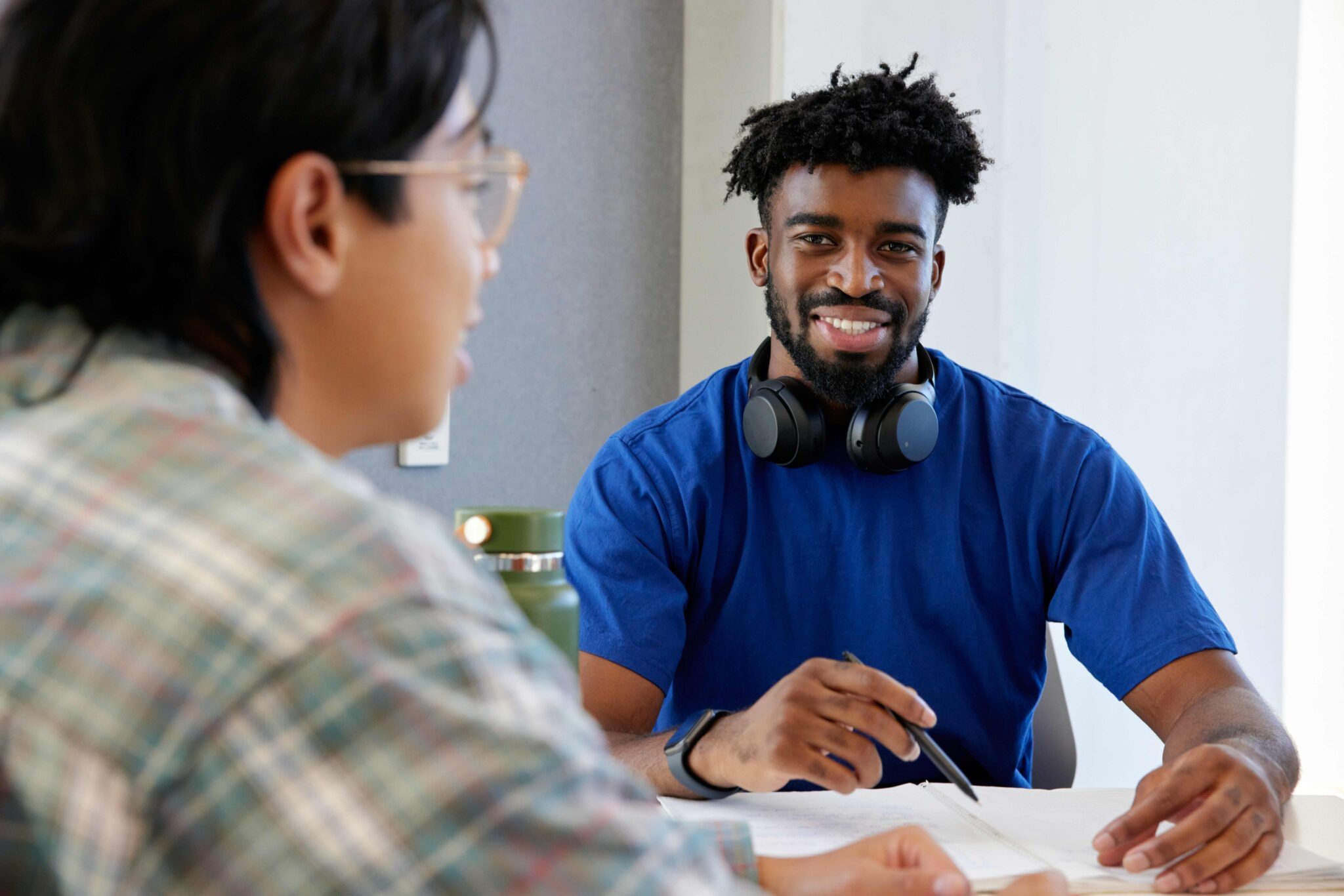 student with headphones sitting at desk