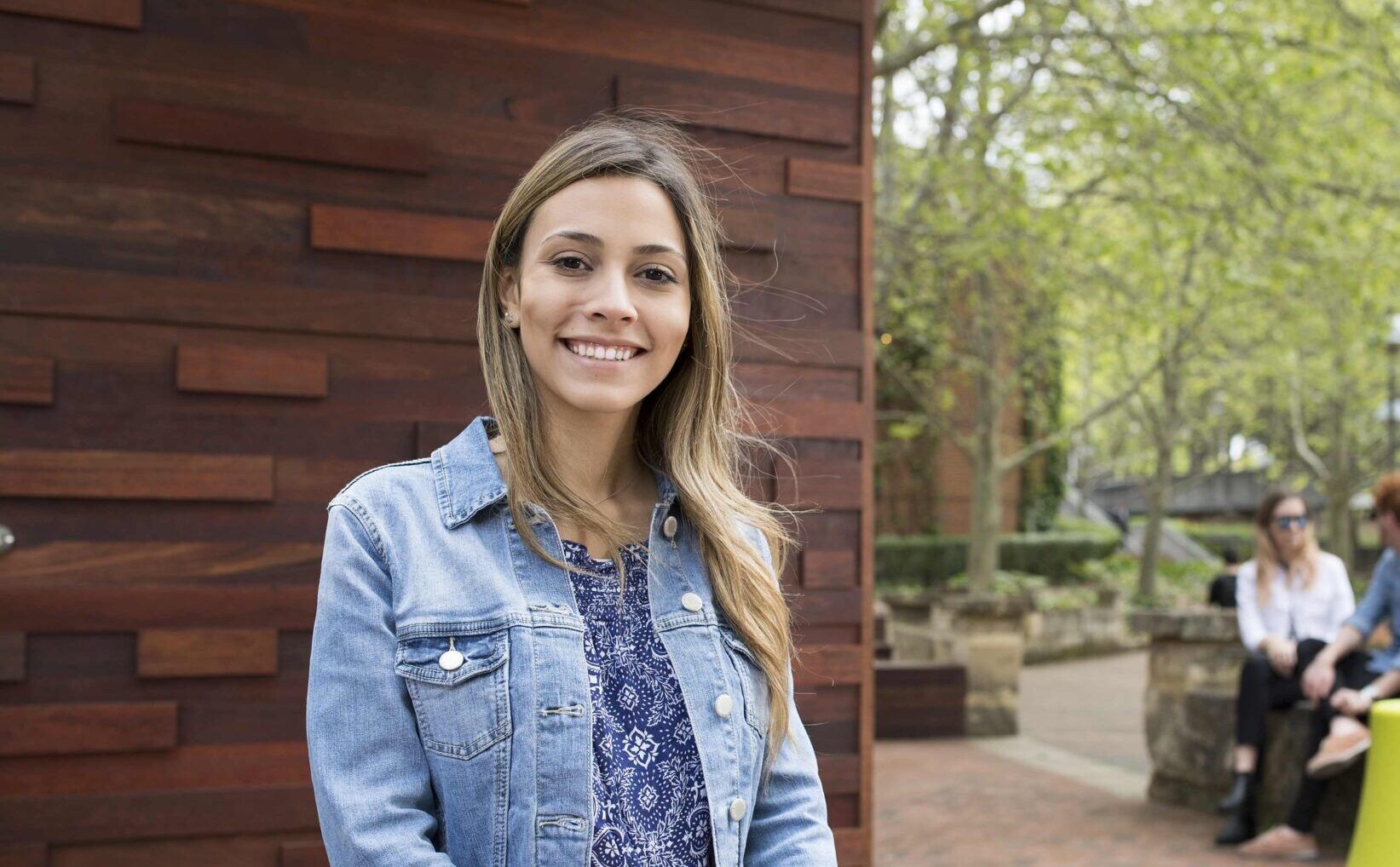 female student standing in front of coffee shop