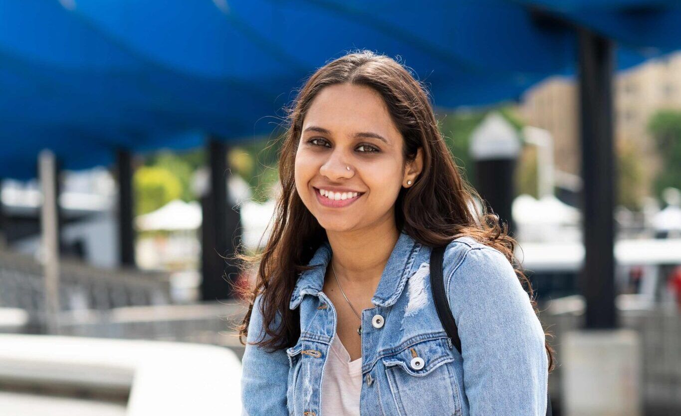 student sitting at a pier