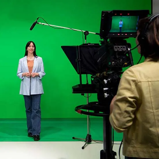 Female media student in Curtin's media production studios talking to a camera