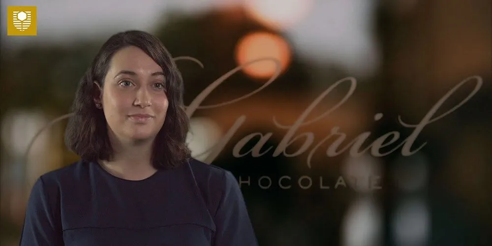 Female student speaking her marketing degree - play video