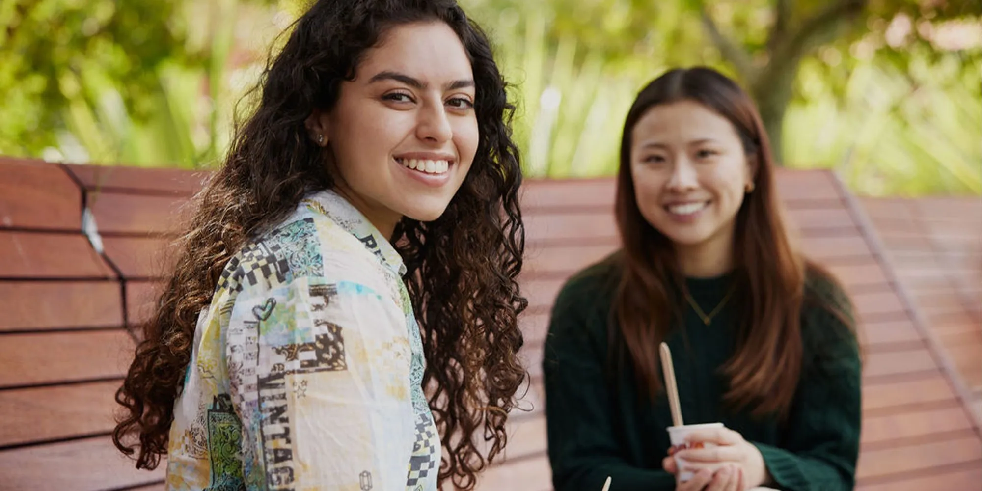 Two students sitting outside together