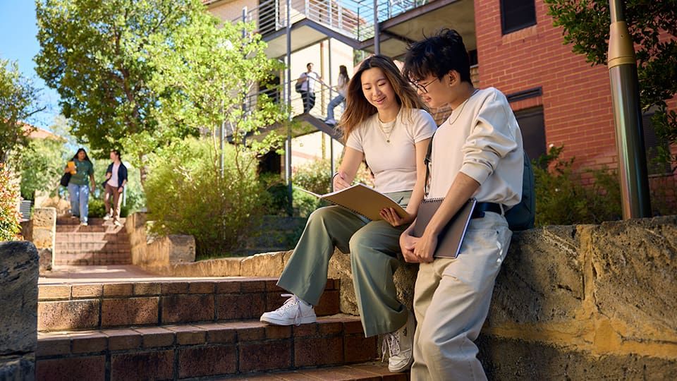 Two students on Curtin campus talking about their study options