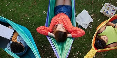 Students relaxing in hammocks