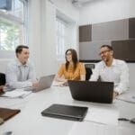 Young professionals sitting at a desk.