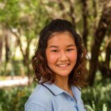 image of curtin student quincy lan in a blue polo shirt against green background