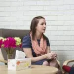 Psychology student with pink scarf during a session