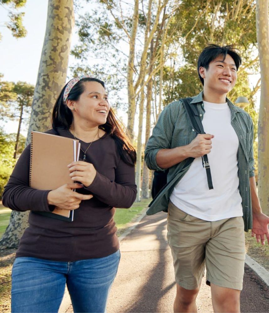 Two students walking on campus grounds.