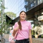 Curtin undergraduate student standing in front of the library