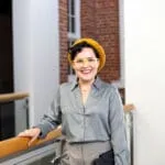 Young professional wearing glasses and a yellow hat