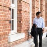 Two Curtin Alumni Scholarship recipients walking next to Curtin Business School