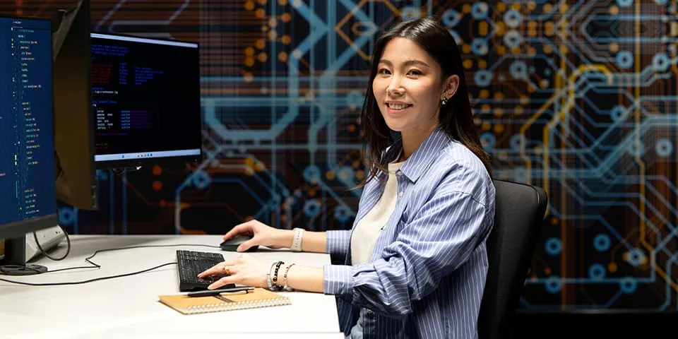 Female Computer Science student sitting at a desk