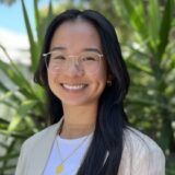 Bachelor of Science (Health Promotion) student smiling with greenery in the background.