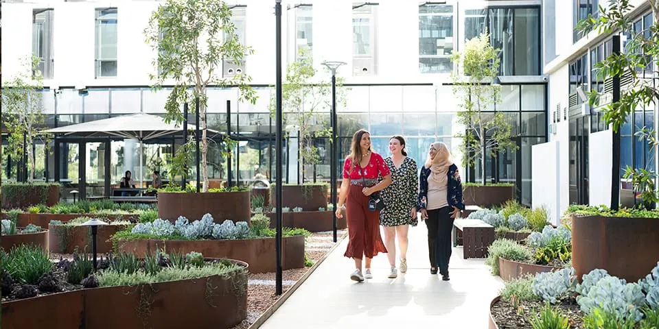 Students walking in the courtyard/garden of St Catherine's College