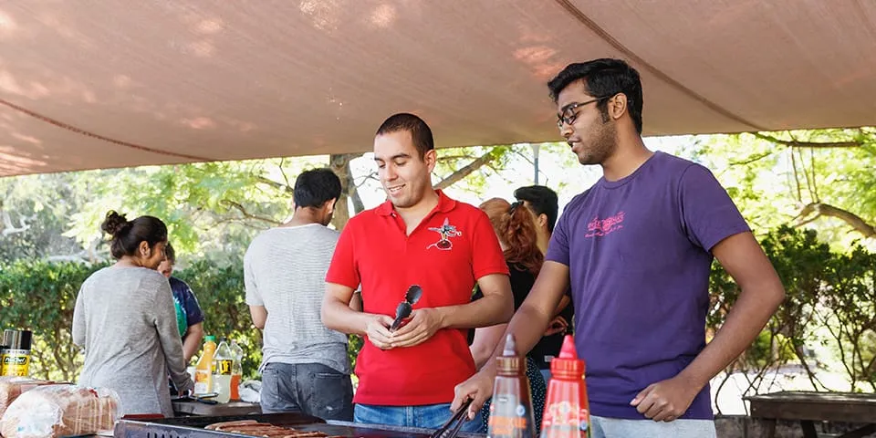 Two students at a barbeque