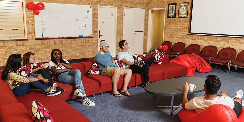 Students sitting on red lounges at Vickery House
