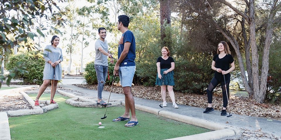 Students enjoying a game of minigolf