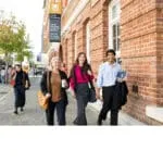 Mature-aged MBA students walking next to the Curtin Business School
