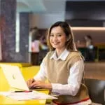 Year 12 student sitting at a yellow table