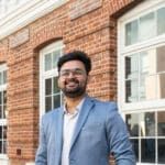 Mature-aged MBA student standing next to the Curtin Business School