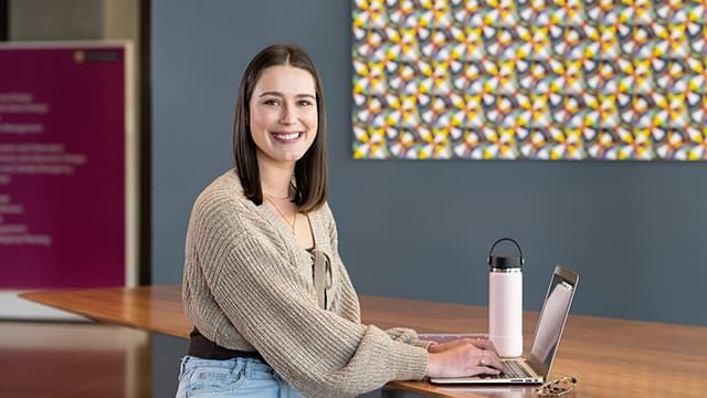 Happy female student writing her scholarship application