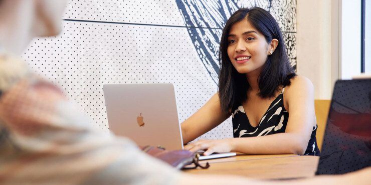 young female student sitting in front of a laptop